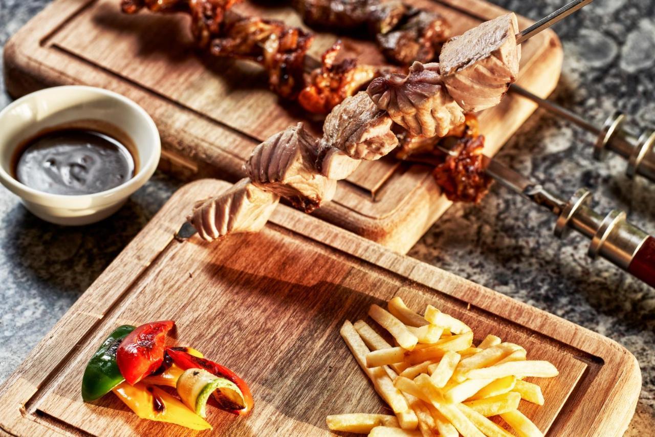 Fanar Hotel & Residences Salalah Extérieur photo A wooden cutting board
