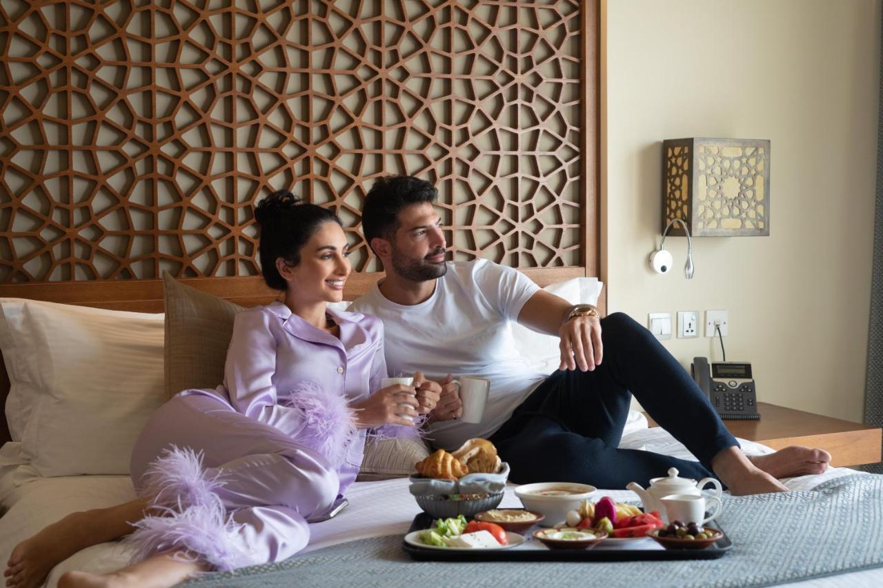 Fanar Hotel & Residences Salalah Extérieur photo A couple having room service
